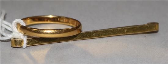 A 22ct gold band and a 9ct tie pin.